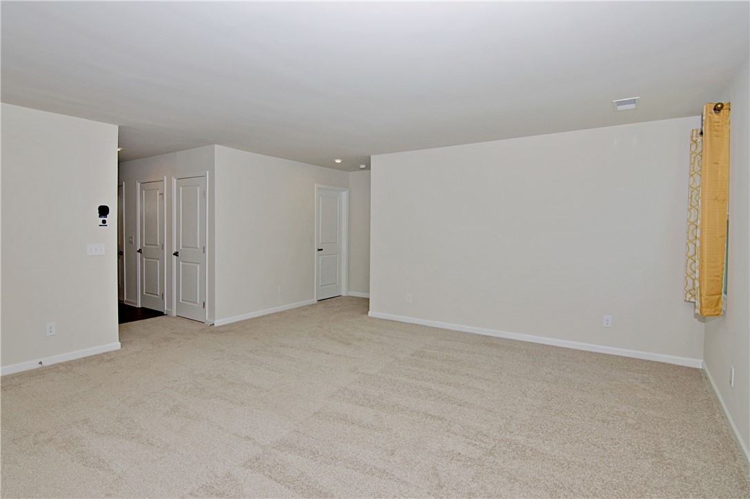 723 Peridot Way Westminster, SC 29693 - Photo 17 of 45 Well-lit and versatile living space featuring neutral tones and plush carpeting.