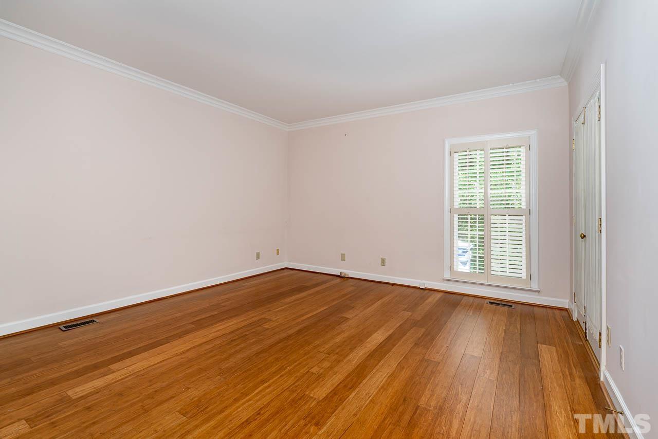 738 Weathergreen Drive Raleigh, NC 27615 - Photo 12 of 31 a view of an empty room with wooden floor and a window