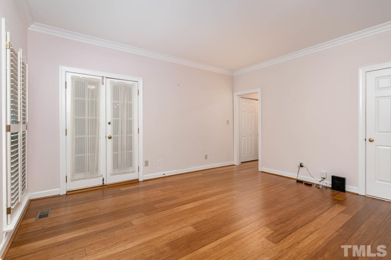738 Weathergreen Drive Raleigh, NC 27615 - Photo 13 of 31 an empty room with wooden floor and windows