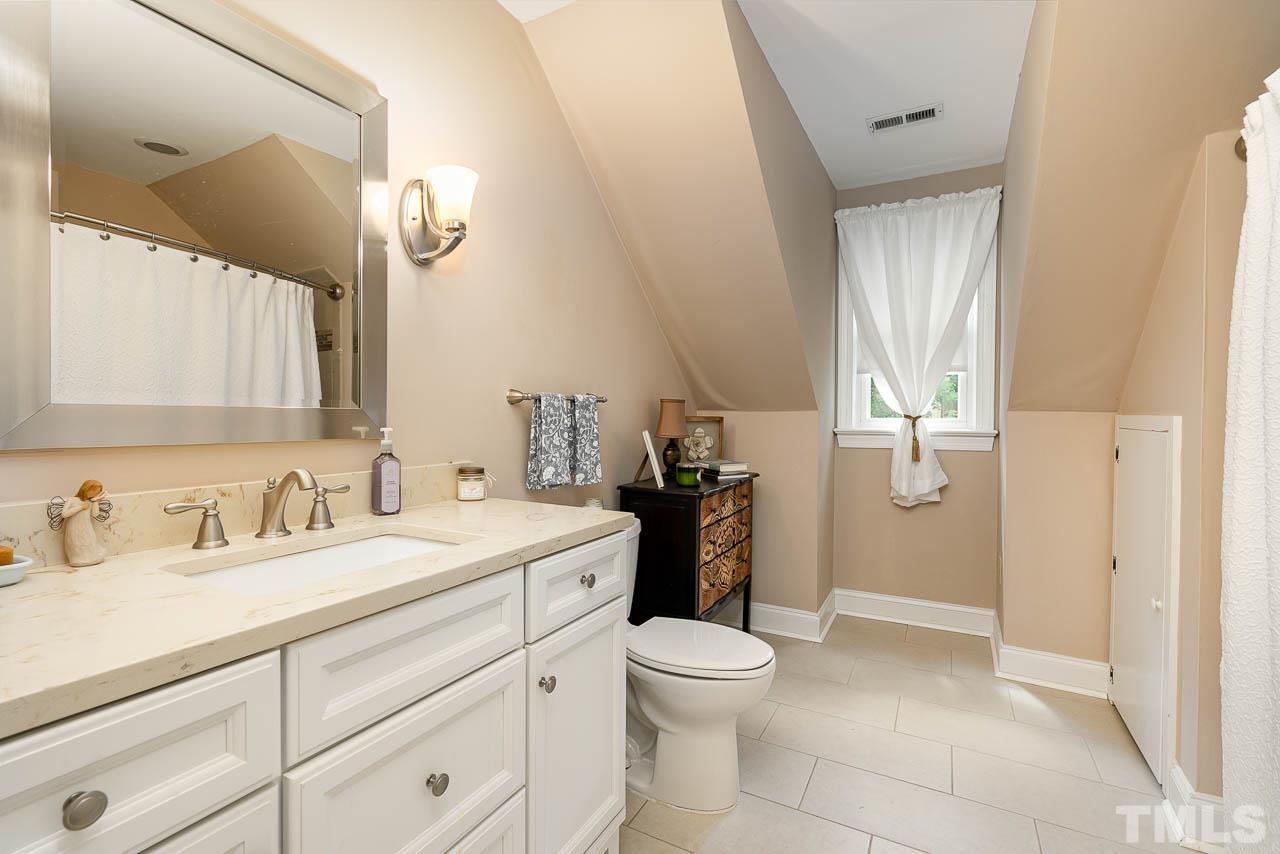 738 Weathergreen Drive Raleigh, NC 27615 - Photo 15 of 31 a bathroom with a sink a toilet and a mirror