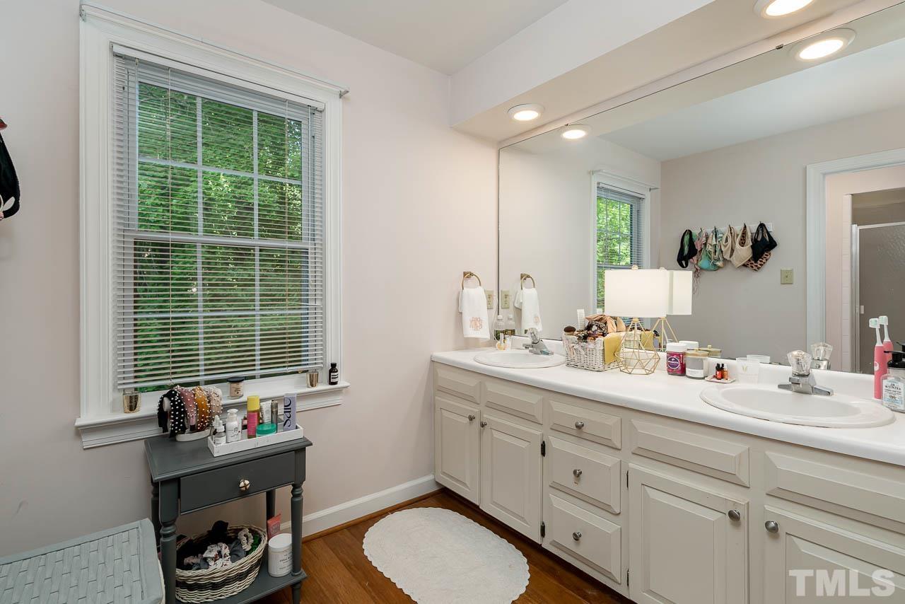 738 Weathergreen Drive Raleigh, NC 27615 - Photo 18 of 31 a bathroom with a granite countertop sink mirror and window
