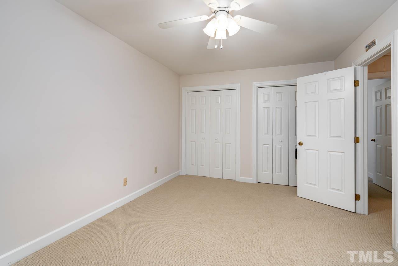738 Weathergreen Drive Raleigh, NC 27615 - Photo 24 of 31 an empty room with a chandelier fan