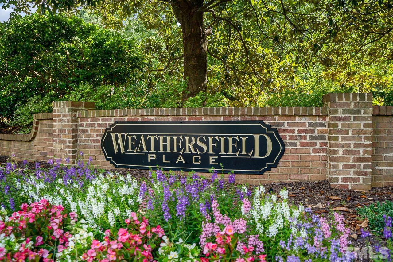 738 Weathergreen Drive Raleigh, NC 27615 - Photo 31 of 31 a sign broad in front of flowers