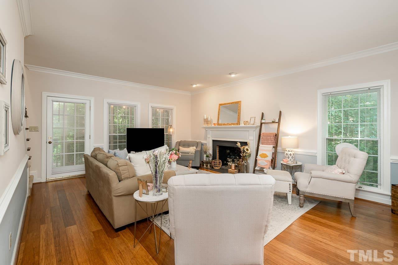738 Weathergreen Drive Raleigh, NC 27615 - Photo 9 of 31 a living room with furniture a fireplace and a flat screen tv