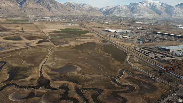 1000 Promontory Road Brigham City, UT 84302 - Photo 3 of 13 Expansive aerial perspective showcasing diverse terrain with a meandering waterway, agricultural fields, and developed areas