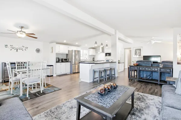 a living room with lots of furniture and kitchen view