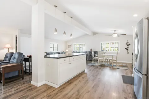 a kitchen with sink cabinets and wooden floor