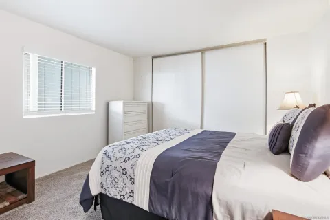 a bedroom with a bed and a lamp