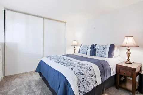 a bedroom with a large bed and a chandelier