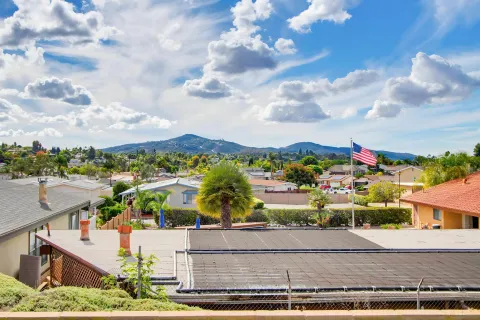 a view of a swimming pool and outdoor seating