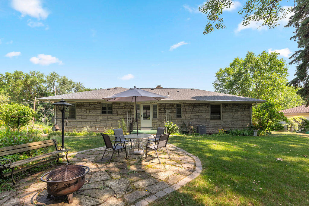 25 Diana Road Portage, IN 46368 - Photo 3 of 17 a view of a patio with table and chairs potted plants and large tree