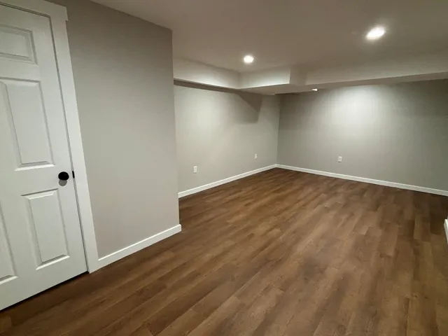 an empty room with wooden floor and closet