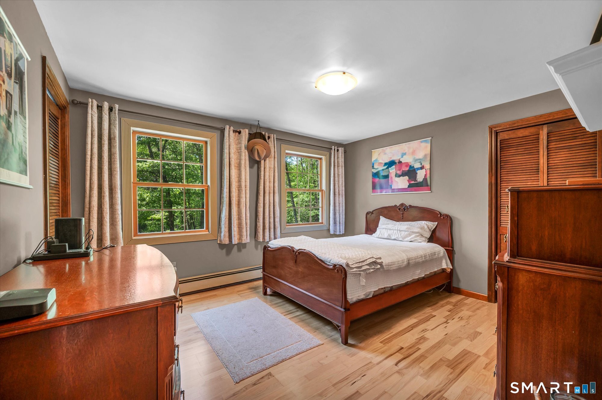 59 Indian Hill Road Canton, CT 06019 - Photo 23 of 39 a bedroom with a bed and wooden floor