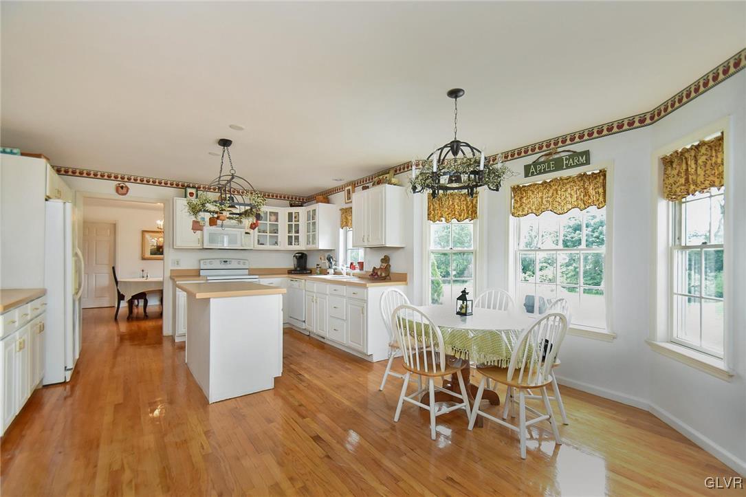 105 Hahn Road Stroudsburg, PA 18360 - Photo 13 of 45 a dining room with wooden floor a chandelier a wooden table and chairs