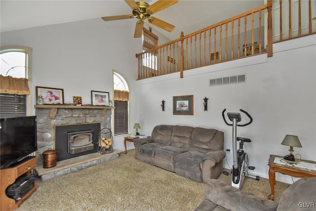 105 Hahn Road Stroudsburg, PA 18360 - Photo 17 of 45 a living room with furniture a fireplace and a flat screen tv
