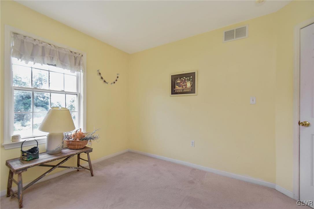 105 Hahn Road Stroudsburg, PA 18360 - Photo 31 of 45 a living room with a chair and a potted plant