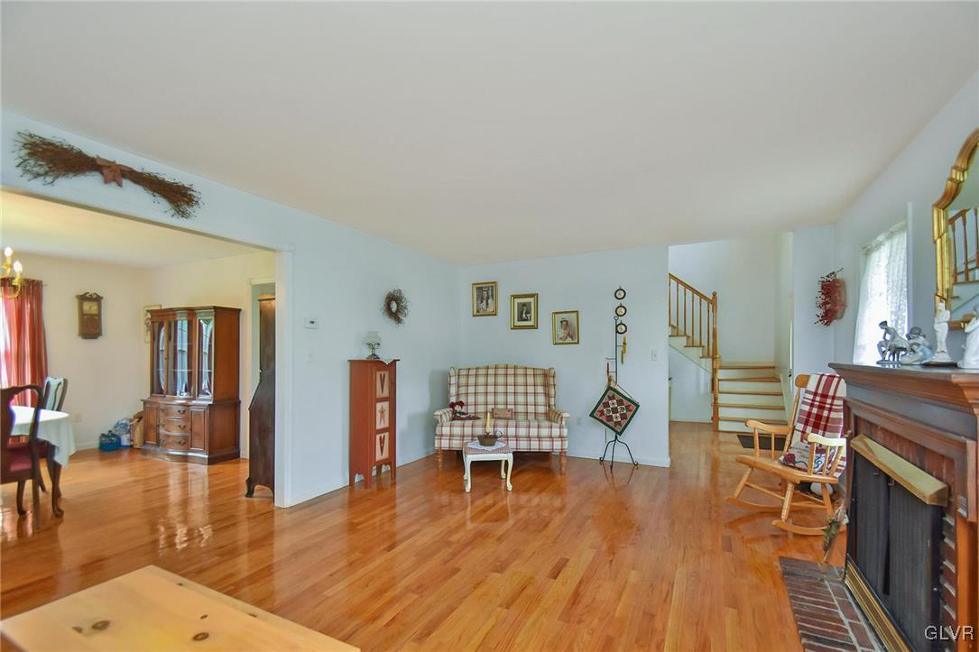 105 Hahn Road Stroudsburg, PA 18360 - Photo 8 of 45 a living room with fireplace furniture wooden floor and a table