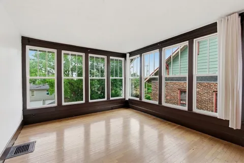 a view of an empty room with large windows