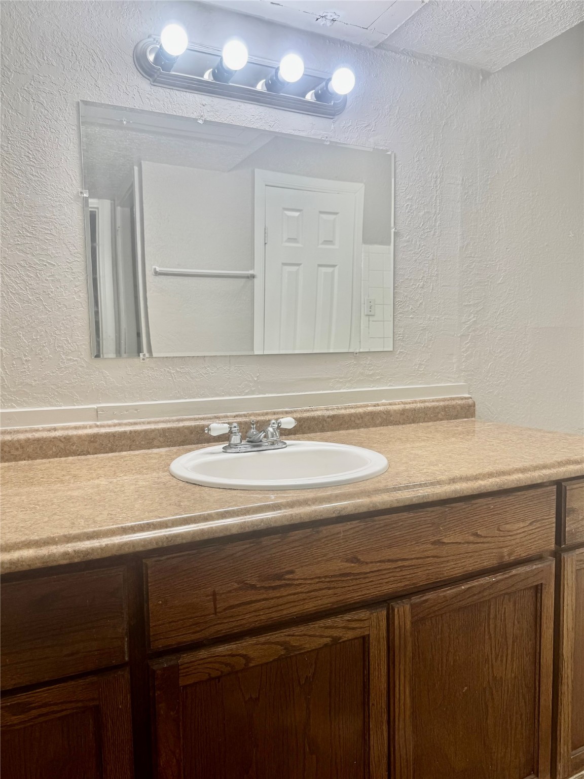 9413 Hollock Street, Unit B Houston, TX 77075 - Photo 11 of 12 a bathroom with a sink and a mirror