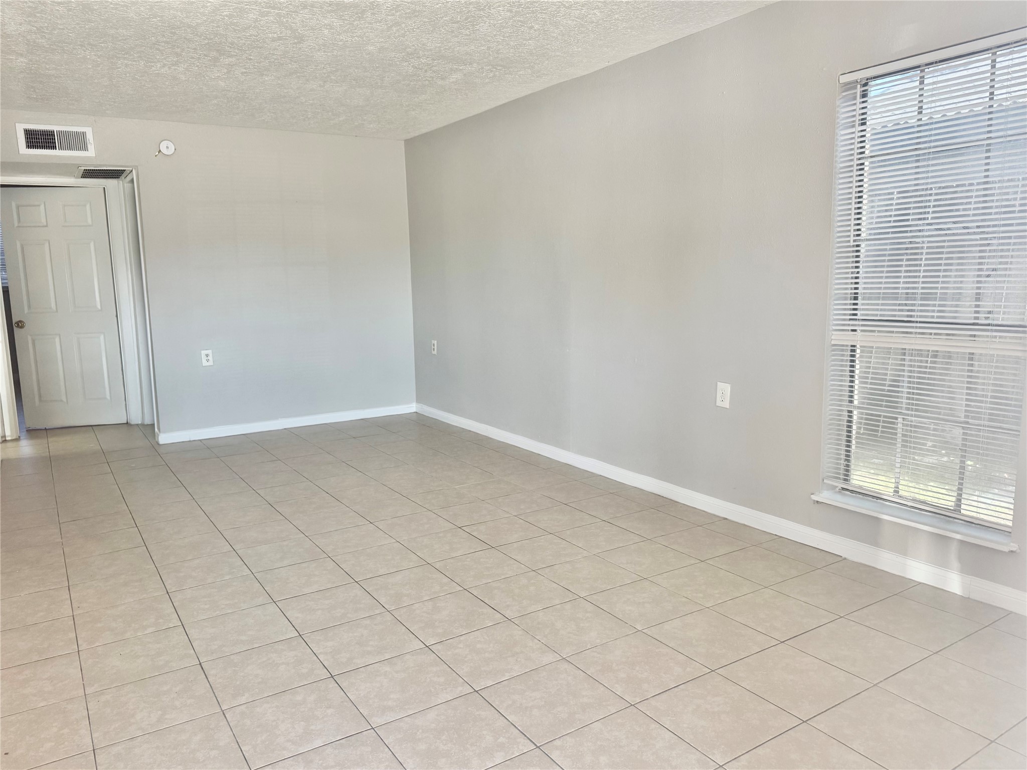 9413 Hollock Street, Unit B Houston, TX 77075 - Photo 2 of 12 an empty room with windows
