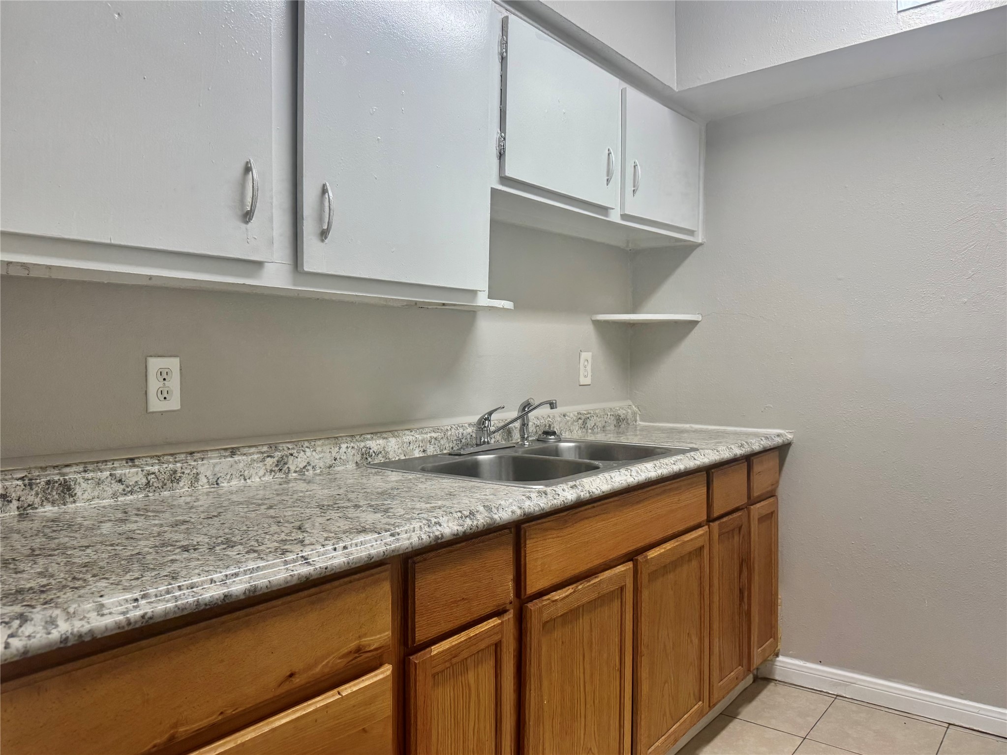 9413 Hollock Street, Unit B Houston, TX 77075 - Photo 6 of 12 a kitchen with granite countertop white cabinets and a sink