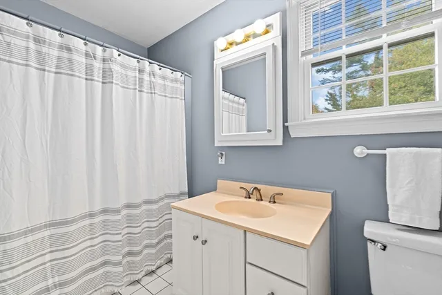 a bathroom with a sink and a shower curtain