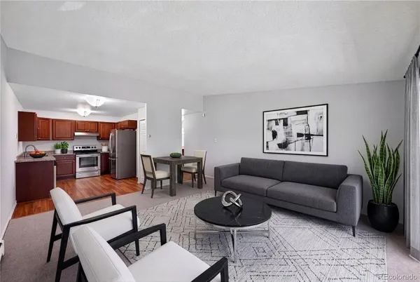a living room with furniture and wooden floor