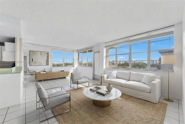 a living room with furniture and a large window