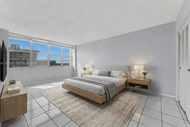 a bedroom with a bed and a view of kitchen