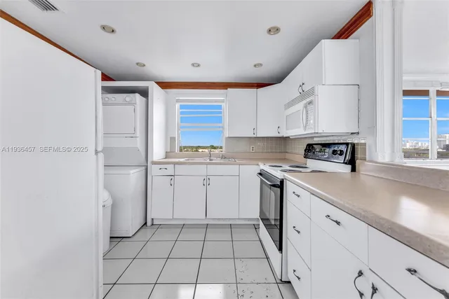 a kitchen with white cabinets and white appliances