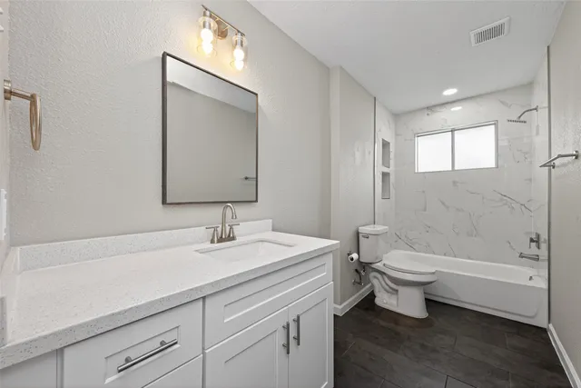 a bathroom with a sink mirror toilet and bathtub