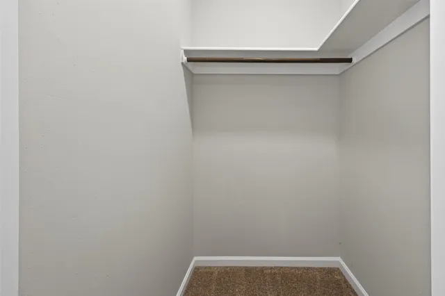 a view of a yard in front of a house with large trees