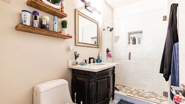 a bathroom with a sink toilet and shower