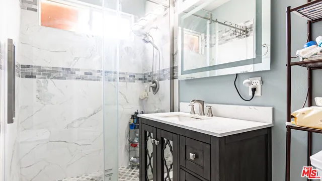 a spacious bedroom with a bed a couch and a fireplace