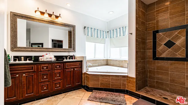 a bathroom with a double vanity sink and mirror