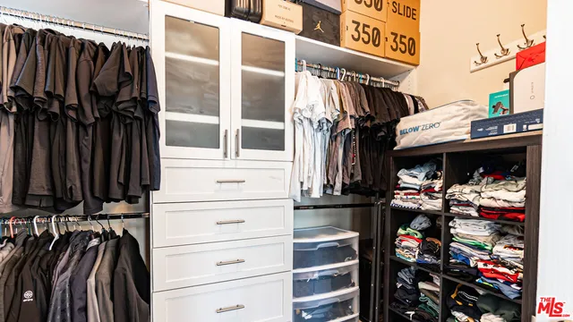 a bedroom that has a bed and a dresser in it