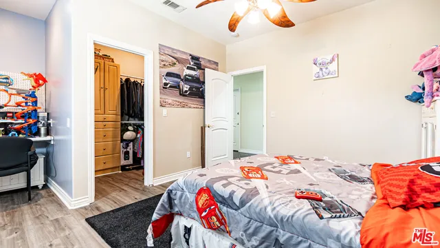 a living room with furniture and a dining table with kitchen appliances