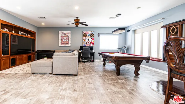 a room with pool table and flat screen tv