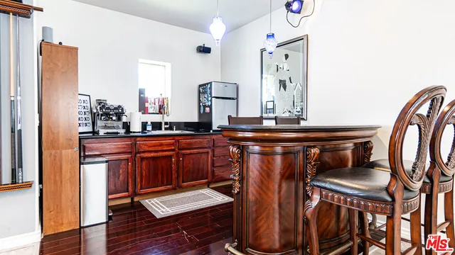 a living room with furniture floor to ceiling window and a flat screen tv