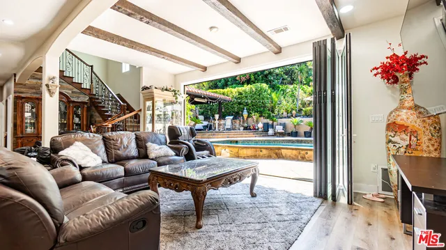 a dining room with furniture potted plants and wooden floor