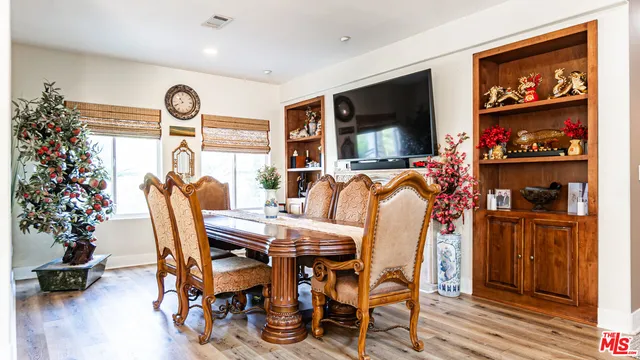a view of a dining room with furniture and a window