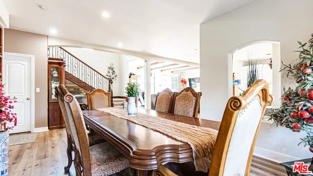 a kitchen with stainless steel appliances granite countertop wooden floor a stove top oven a sink dishwasher and cabinets with wooden floor