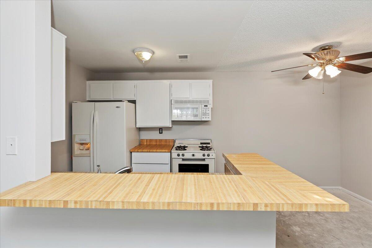 26200 Redlands Boulevard, Unit 68 Redlands, CA 92373 - Photo 18 of 32 a bedroom with a bed and a chandelier