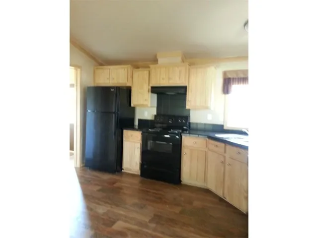 a kitchen with a refrigerator and a stove