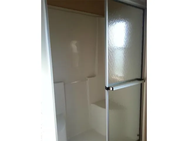 a bathroom with a glass shower door