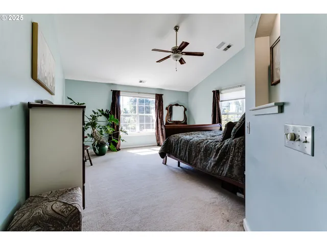 a bedroom with a bed a mirror and dresser