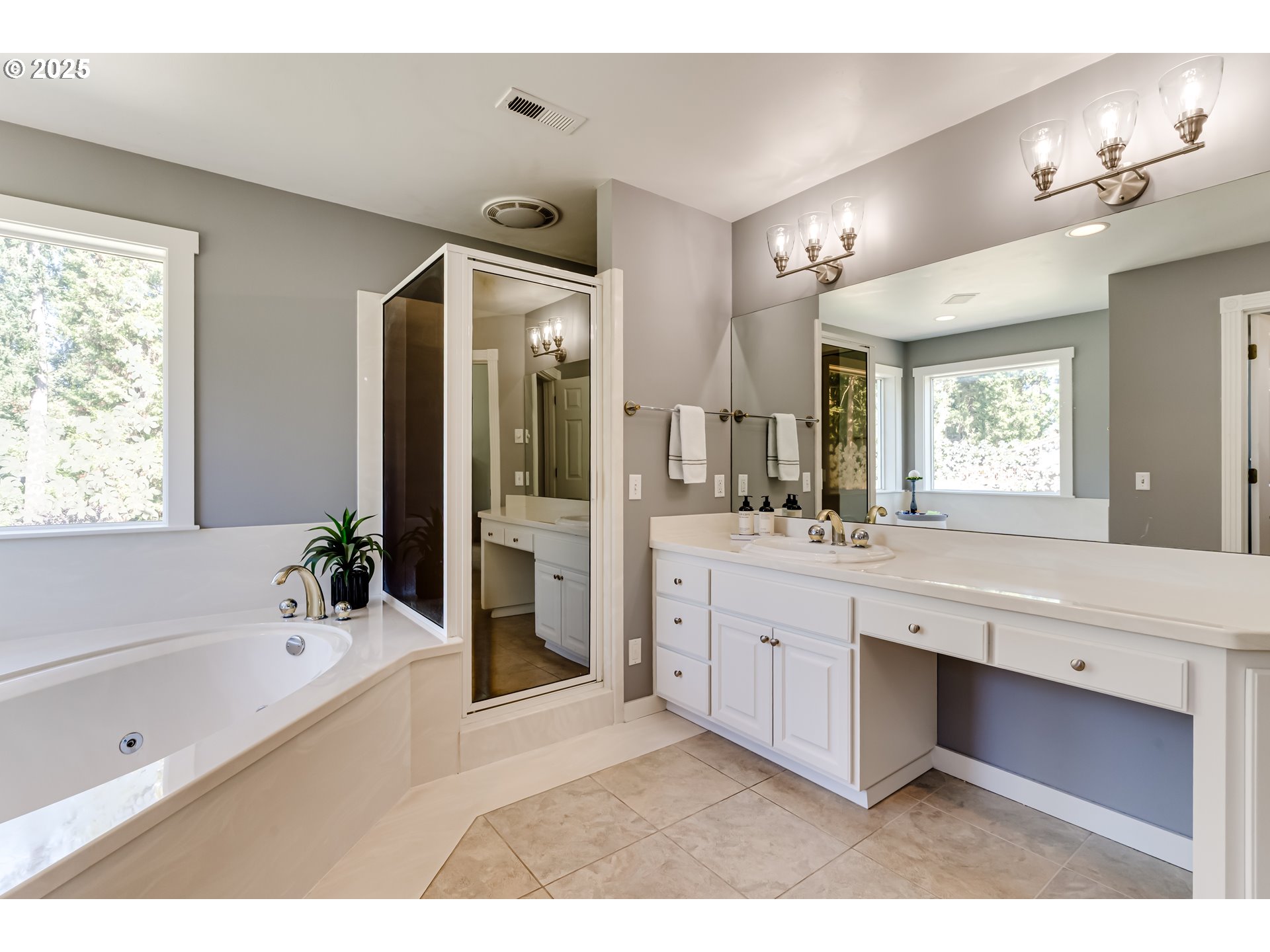 39125 Easton Lane Springfield, OR 97478 - Photo 25 of 47 a bathroom with a tub a double vanity sink a large mirror and a shower