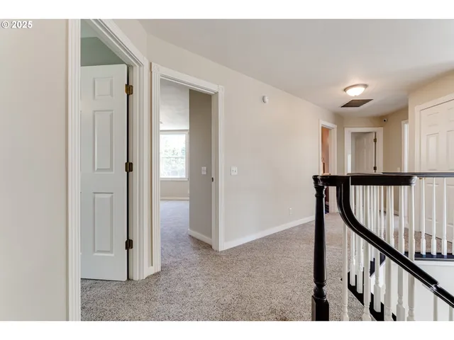 a bedroom with a bed chandelier and a window