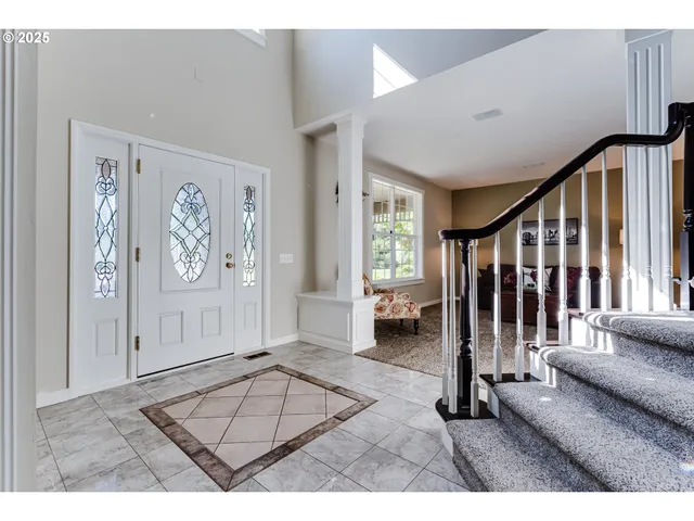 a view of an entryway with wooden floor