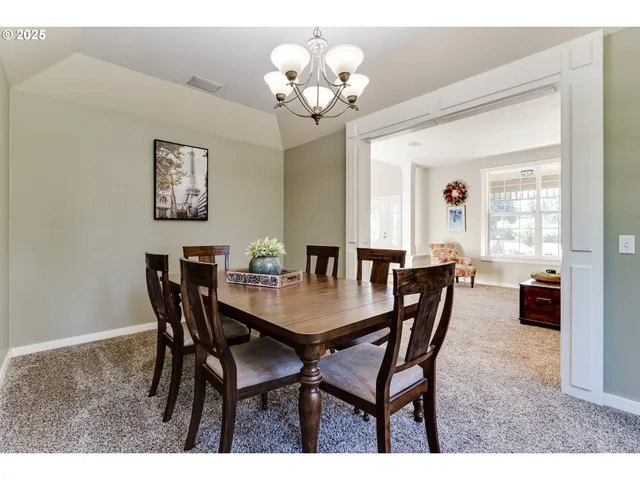 a view of a dining room with furniture and chandelier